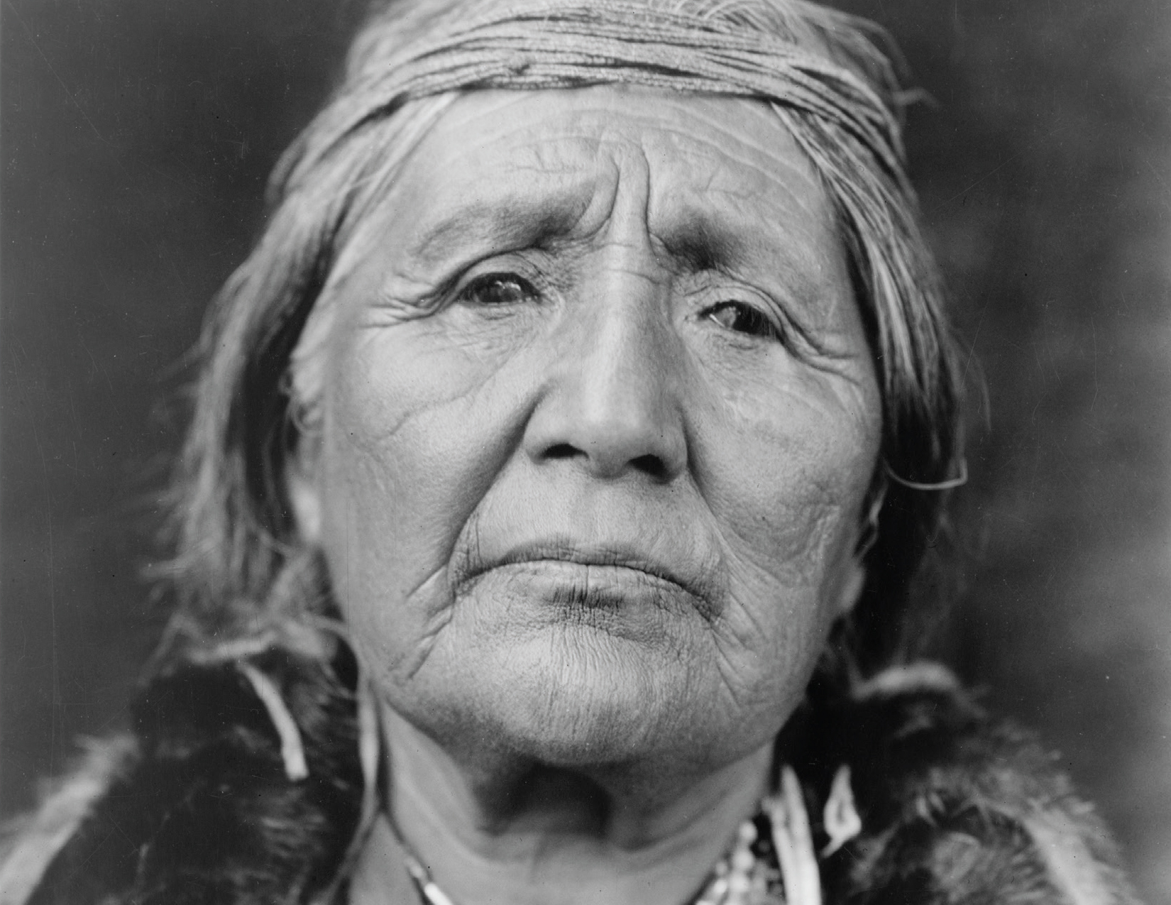 Black and white headshot of an elderly person.
