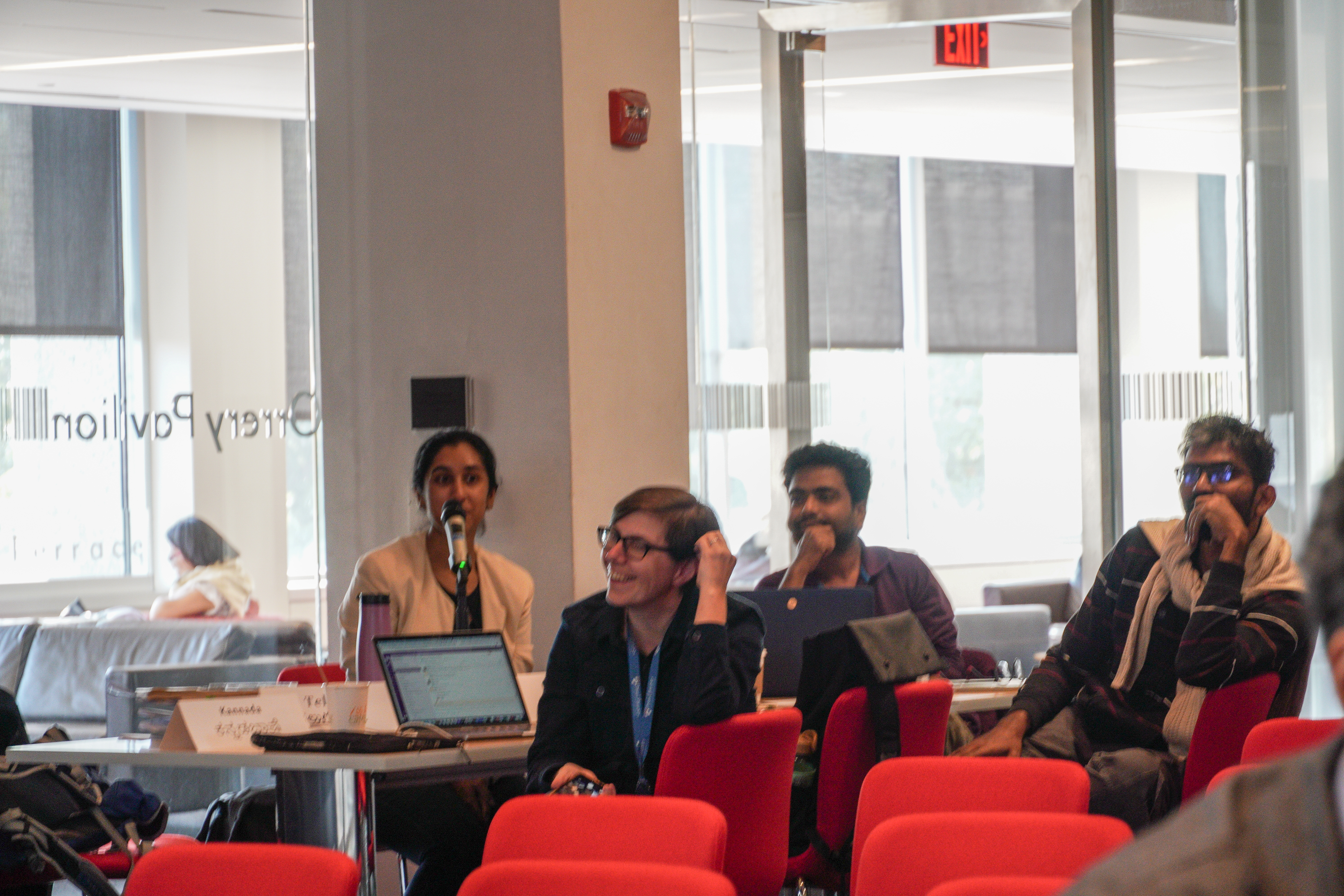 people at a table with laptops smiling