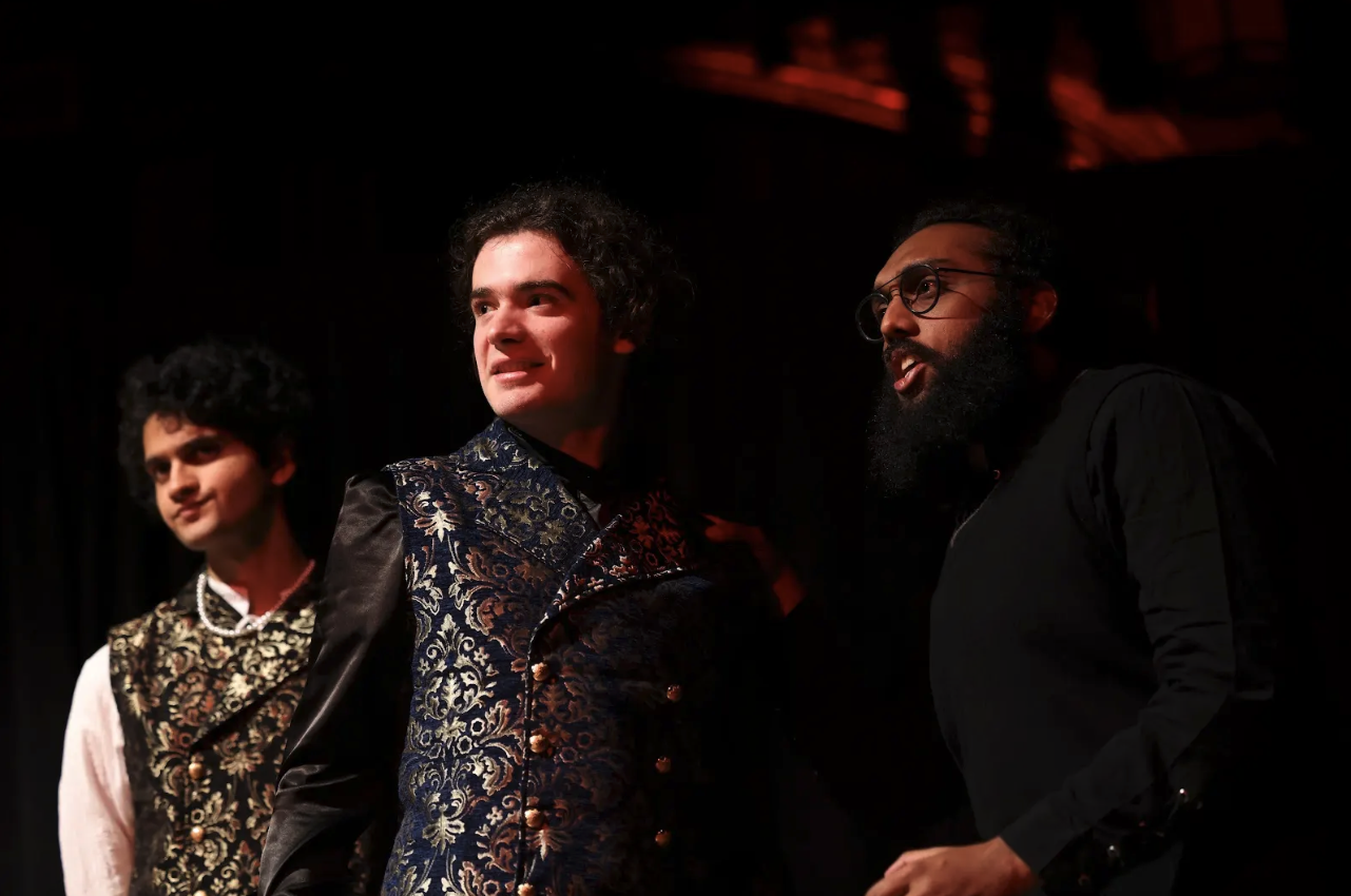 Three men performing on stage